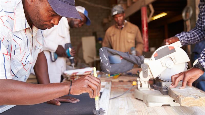 Group of men working on hand making in a small business
