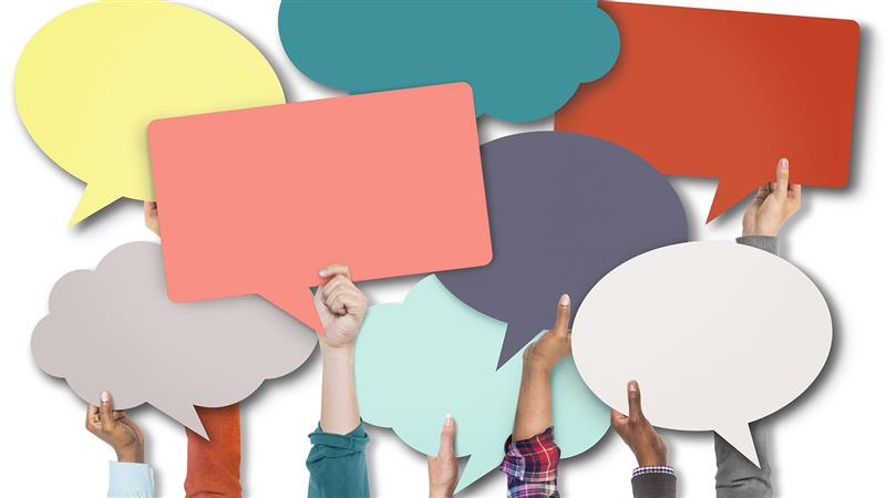 a group of hands holding blank speech bubbles