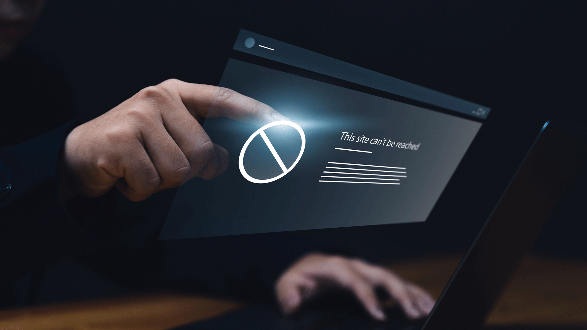 Male hands touching the screen of a pc with message saying 'This site can't be reached'