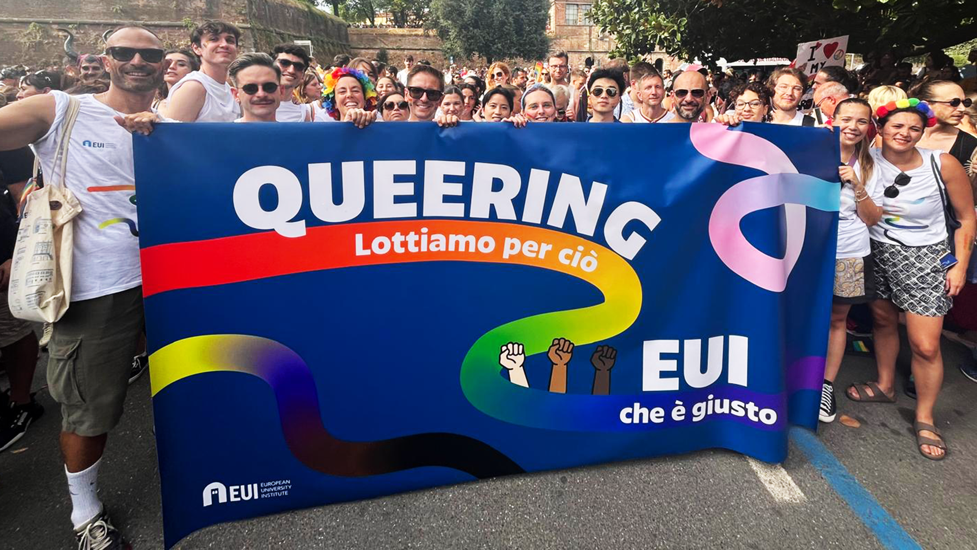 Photo of a group of people with EUI Pride banner in front