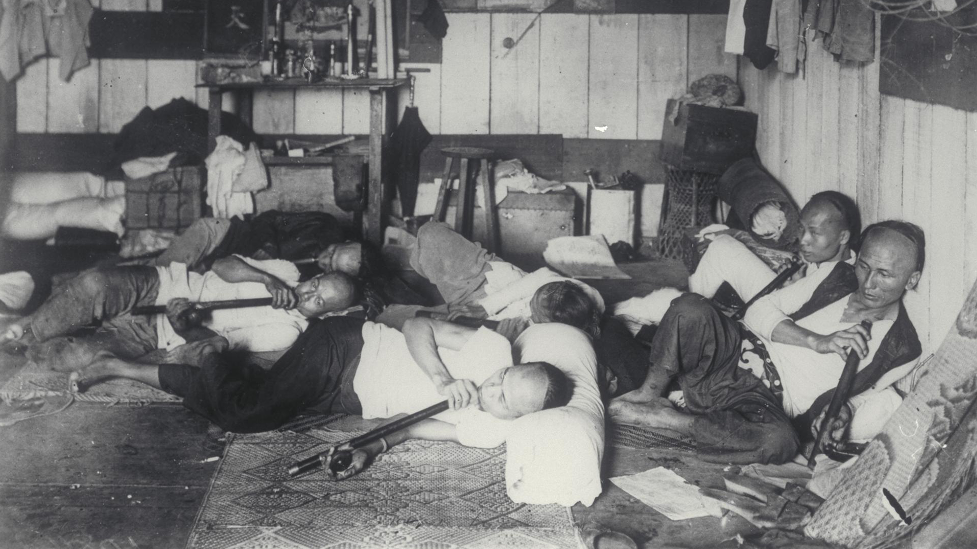 black and white photo with group of people laying on ground