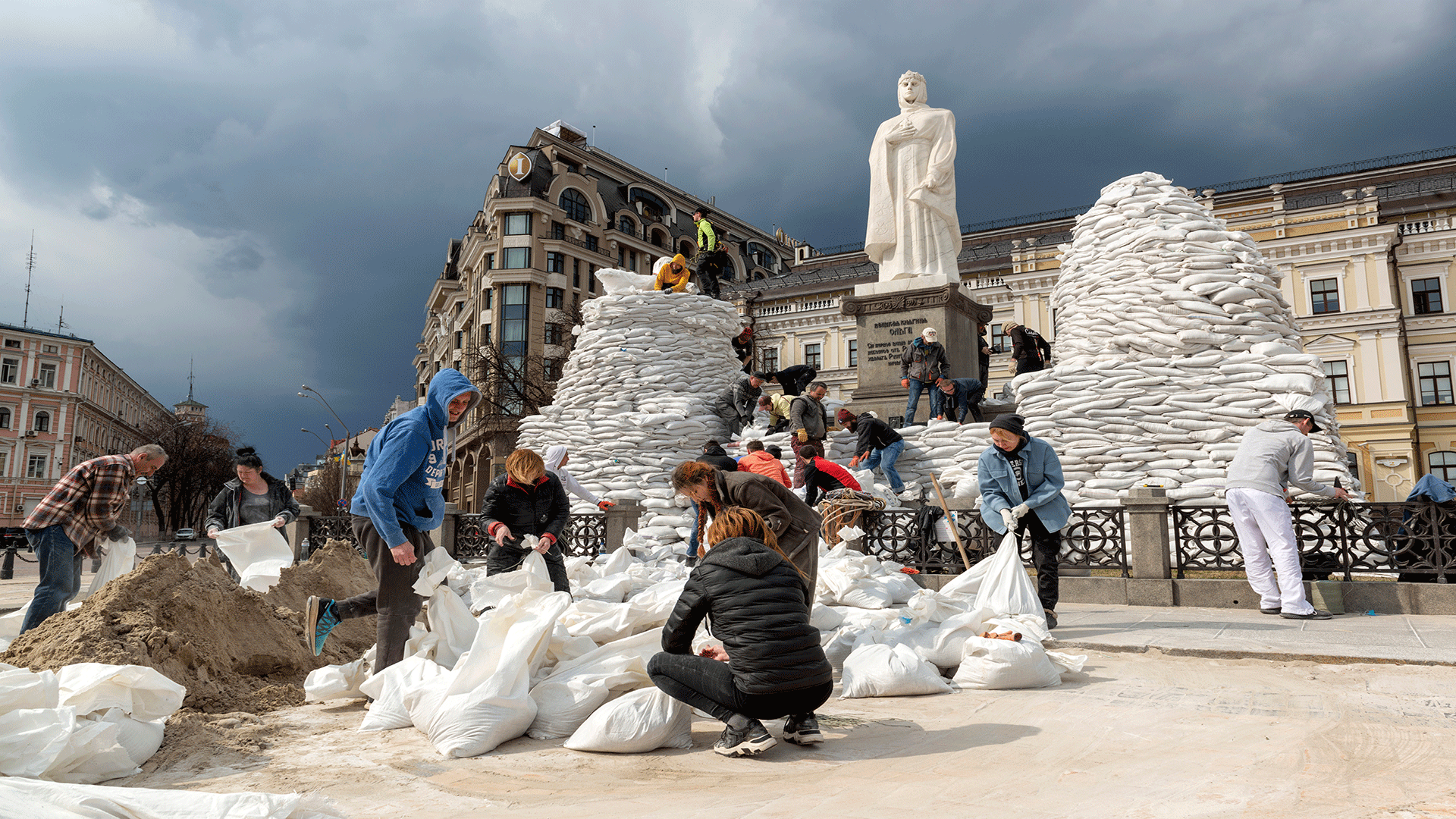 Group of young people in square protesting and building sand barriers 