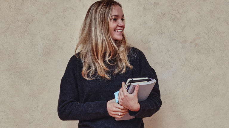 Happy student with books